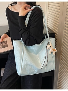 Sky blue large capacity tote bag with glossy wrinkled texture and horse charm pendant