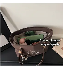 Deep brown canvas tote bag interior showing large capacity for essentials and phone