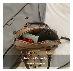 Top view of brown leather bag interior showing capacity for smartphone and makeup