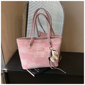 Pink pixel-patterned fabric tote bag with slim shoulder strap and horse charm detail