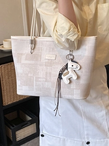 Minimalist large capacity bucket tote bag with geometric pattern and pony charm detail