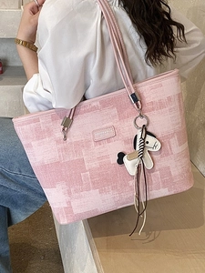 Pink geometric pattern large bucket tote bag with pony charm shown on female model