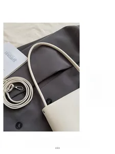 Detail of soft white leather bucket bag with detachable silver metal buckle strap