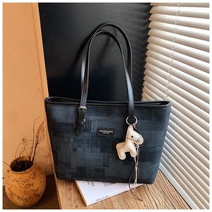 Detailed close-up of dark blue mosaic patchwork tote with black leather straps