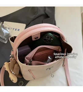 Top view of color-block bucket bag interior showing smartphone and wallet storage