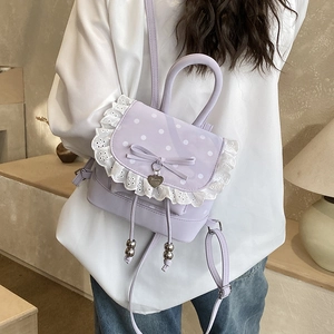 Dettaglio zainetto lavanda con pois bianchi, bordo in pizzo e fiocco decorativo