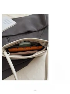 Top view of white leather shoulder bag interior showing capacity for phone and wallet
