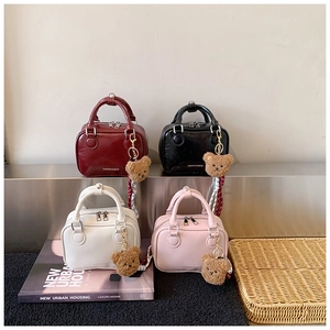 Mini handbag collection in four colors with plush bear charm and striped ribbon detail