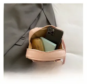 Detail showing internal storage capacity of the pink pleated PU leather crossbody bag
