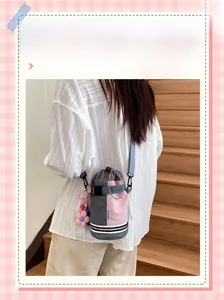 Pink plaid bicycle water bottle bag with blue shoulder strap and flower charm detail