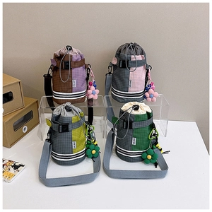 Detail view of colorful outdoor water bottle bags with drawstring and flower charms
