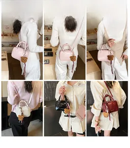 Model showcasing four color variations of the mini Boston crossbody bag with bear charms
