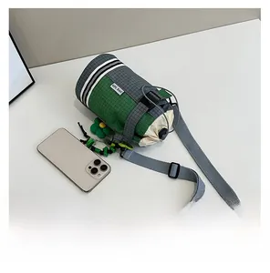 Top view of cross-body water bottle bag with drawstring closure and phone size comparison
