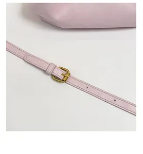 Detail view of the adjustable purple leather shoulder strap with a gold metal buckle