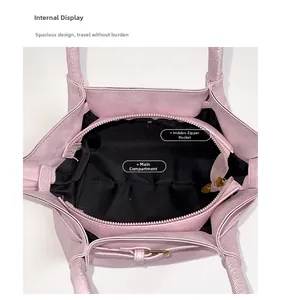 Detailed interior view of pink bucket bag showing main compartment and gold zipper pocket