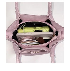Top view of pink bucket bag showing three-layer interior capacity with zipper pocket