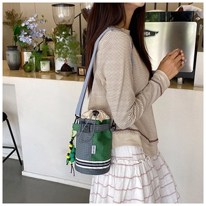 Outdoor crossbody water bottle bag with drawstring closure and decorative bead charm