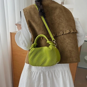 Lime green ruched bucket bag detail showing matte leather texture and gold hardware hooks