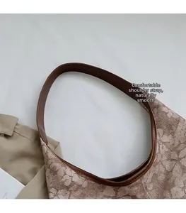 Detail view of the floral jacquard fabric and comfortable leather shoulder strap