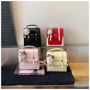 Polka dot mini backpacks in multiple colors with metal handles and owl plush charms