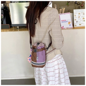Outdoor crossbody water bottle bag with purple plaid pattern and floral charm detail