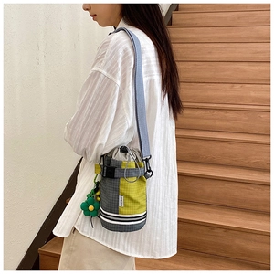 Detail of checkered cycling bottle bag with drawstring closure and sunflower charm