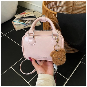 Pink crinkled patent leather mini square bag with a cute brown plush bear charm