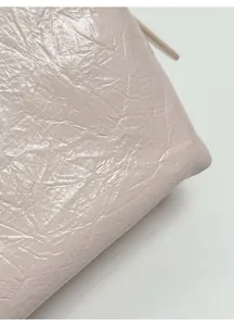 Close-up of soft textured leather material with natural grain on a luxury tote bag