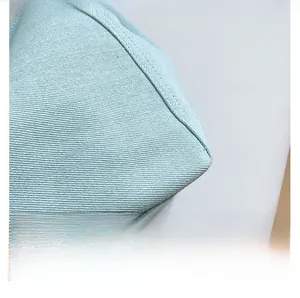 Detailed macro view of light blue denim fabric texture and durable double-stitched seams