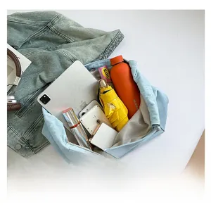 Internal storage display of large capacity denim tote bag holding iPad and daily essentials