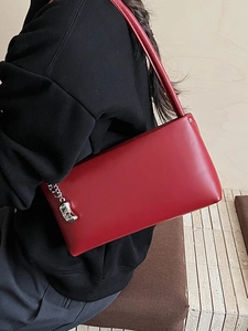 Chic dark red baguette shoulder bag in smooth leather featuring a silver chain detail