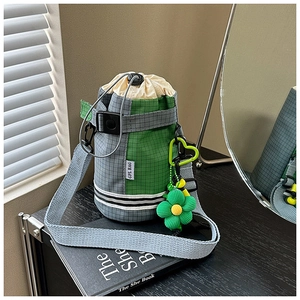 Detail of grey and green outdoor drawstring bottle bag with adjustable shoulder strap