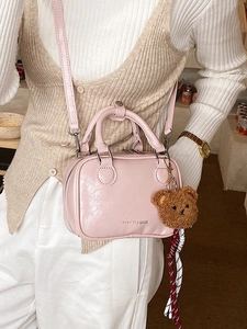 Pink Boston style small crossbody bag with teddy bear pendant and woven ribbon decor