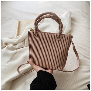 Close-up of Morandi pink pleated bucket bag with dual handles and gold-tone metal hardware