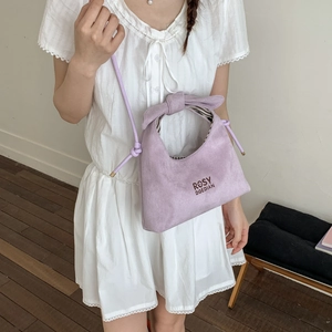 Minimalist lavender dumpling bag with ribbon handles and adjustable shoulder strap