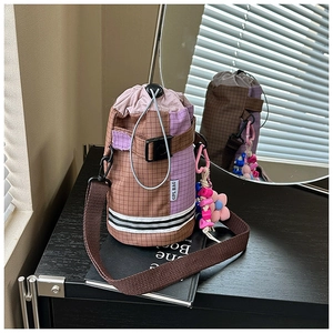Detail of checkered cycling water bottle bag with drawstring closure and floral charm