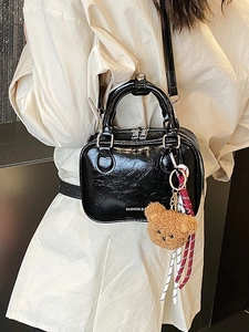 Fashionable black glossy patent leather crossbody bag with a plush bear charm for women