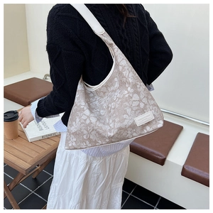 Detail of floral tote bag with adjustable strap and vintage flower pattern on fabric