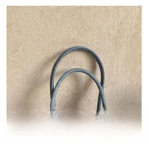 Detail of sturdy dual top handles with floral fabric and vintage metal buckles on handbag