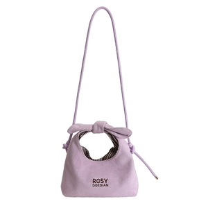 Fashionable lavender suede hobo bag with bow handle and crossbody strap