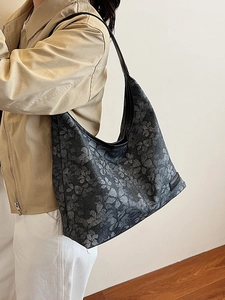 Large dark grey floral tote bag with black leather straps shown on model for daily use