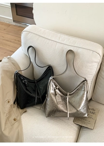 Detail of black and silver crinkled leather hobo bags with minimalist retro style