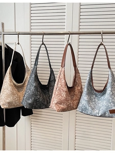 Floral hobo shoulder bags in various colors displayed on a rack for a casual commuter look