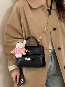 Glossy black crossbody bag with gold lock, chain strap and cute bear charm for women