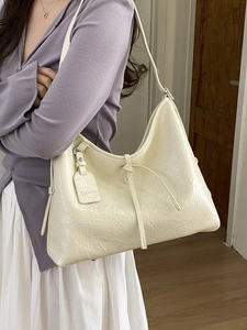 Fashionable off-white tote bag with pleated texture and stylish drawstring design