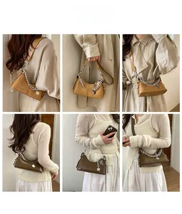 Detail showing dual strap options with silver chain and long leather shoulder strap on hobo bag