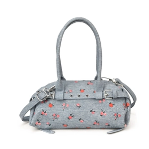 Light blue floral denim shoulder bag with red patterns and adjustable crossbody strap