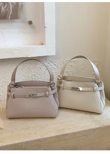 Detailed close-up of textured pebbled leather bags with elegant metallic lock buckles