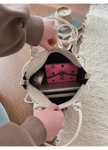 Top view of white leather bucket bag interior showing spacious storage for daily essentials