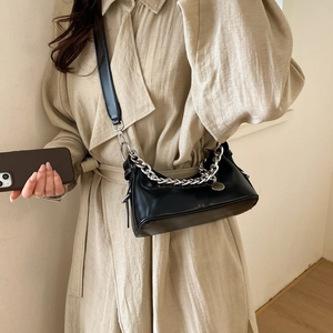Detail of black moon bag with chunky silver chain and adjustable leather shoulder strap
